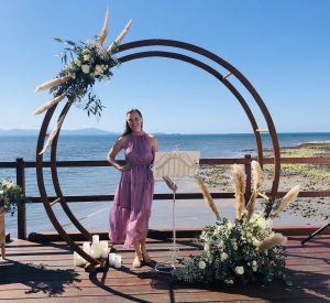 Cairns marriage celebrant Andrea Allumay under wedding arch